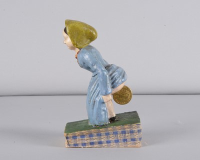 Lot 245 - A mid 19th century Thüringen Dukatenscheißerin woman ‘shitting’money squeak toy