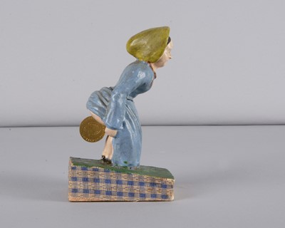 Lot 245 - A mid 19th century Thüringen Dukatenscheißerin woman ‘shitting’money squeak toy