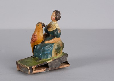 Lot 249 - A mid 19th century Thüringen seated woman with large bird squeak toy