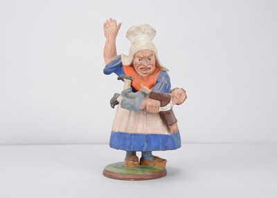 Lot 252 - A Thüringen composition nodder grotesque woman beating a child, mid to late 19th century