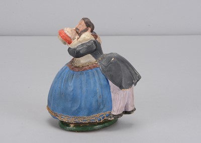 Lot 254 - A mid 19th century German swivelling embracing couple