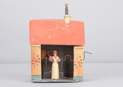 Lot 267 - A 19th century Erzgebirge painted wooden kitchen house crank toy