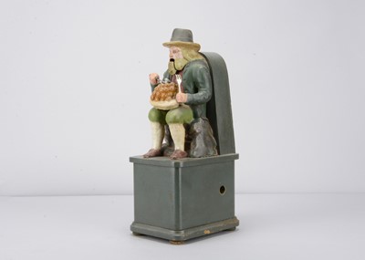 Lot 270 - A late 19th century  Black Forest carved wooden clockwork figure of a resting traveller dumpling eating