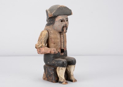 Lot 271 - An early 19th century Black Forest folk art carved wooden articulated figure of a resting traveller dumpling eating