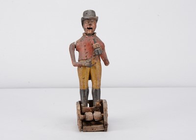 Lot 272 - An 18th or early 19th century folk art carved wooden huntsman drinking figure on straw work base