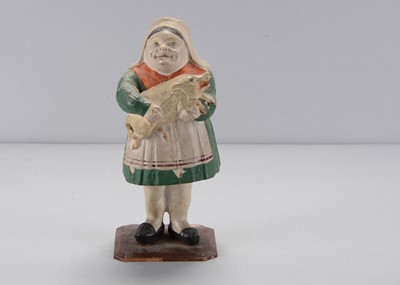 Lot 282 - A mid 19th century Thüringen woman holding a pig swayer