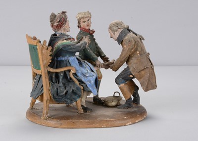 Lot 310 - A mid 19th century Rhöner carved wooden and papier-mâché Rhönwackler woman having her foot bled