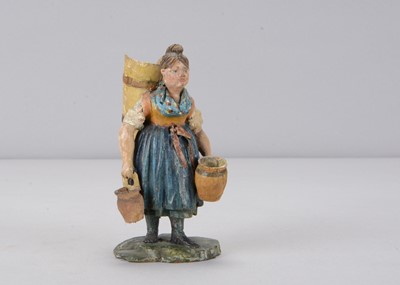 Lot 313 - A mid 19th century Rhöner carved wooden girl carrying wine hod