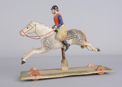 Lot 359 - A mid 19th century Thüringen composition jockey riding grey horse pull along toy