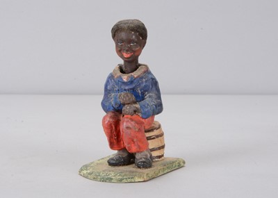 Lot 363 - A late 19th century Thüringen seated black boy nodder