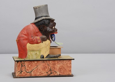 Lot 368 - A late 19th century Thüringen black man eating a bird crank handled ‘eater’