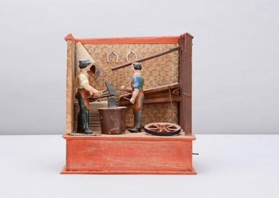 Lot 376 - A mid 19th century Thüringen papier-mâché and wood blacksmith’s forge mechanical toy