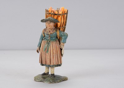 Lot 398 - A mid 19th century Rhöner carved wooden girl heading to market