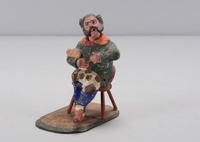 Lot 412 - A mid 19th century Thüringen seated man with spaniel and pug nodder