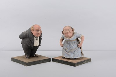 Lot 425 - A mid 19th century composition Old Fezziwig and Mrs Fezziwig dancing sweet or trinket containers