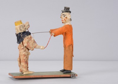 Lot 432 - A late 19th or early 20th century German pull-along clown and dancing poodle toy