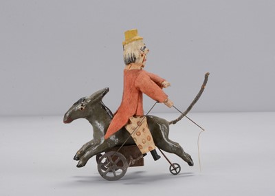 Lot 434 - An early 20th century German composition clockwork clown riding a donkey backwards