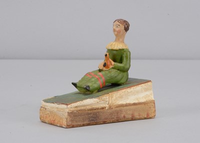 Lot 448 - A mid 19th century Thüringen papier-mâché girl and yellow bird squeak toy