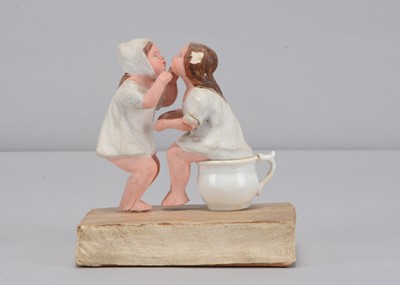 Lot 449 - A mid 19th century Thüringen papier-mâché two girls kissing squeak toy