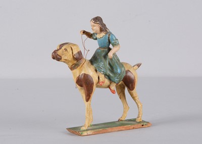 Lot 450 - A mid 19th century Thüringen papier-mâché girl riding a hound