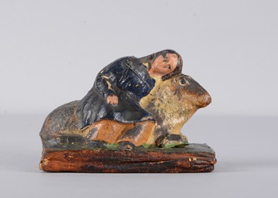 Lot 453 - A mid 19th century Thüringen papier-mâché boy and sheep squeak toy