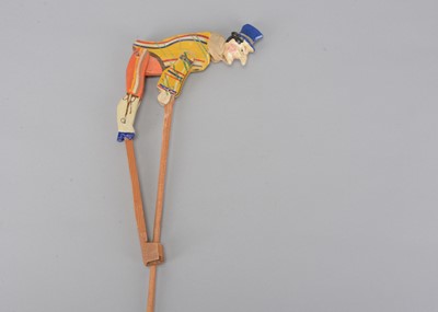 Lot 490 - A late 19th century Thüringen wooden hand held clown somersaulting toy