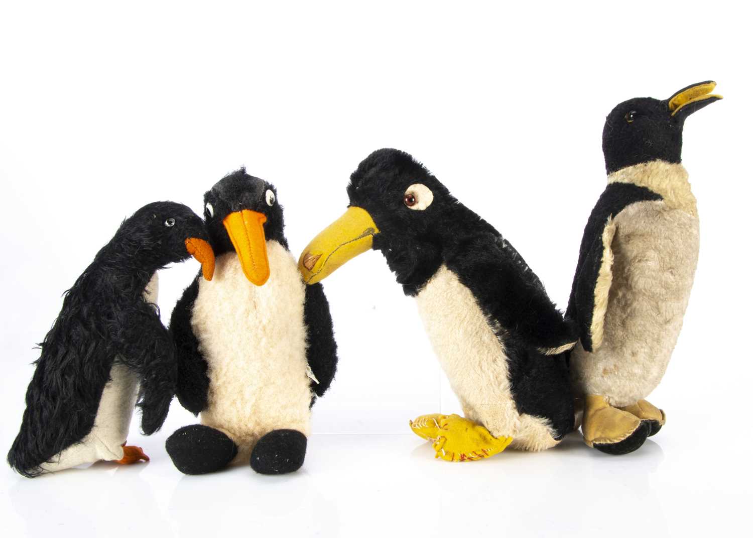 Lot 75 - Four British soft toy penguins