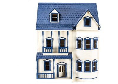 Lot 245 - A recent painted wooden dolls' house, painted cream and blue with shingled roof