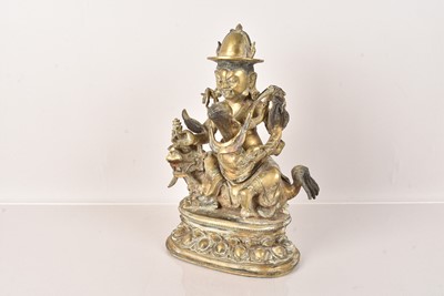 Lot 477 - A Tibetan Bronze Vaishravana on a Lion