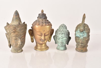 Lot 494 - Four small Buddha Heads