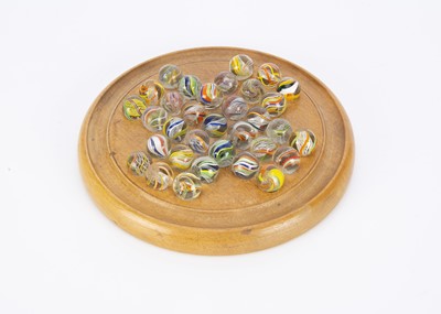 Lot 325 - A small turned wooden solitaire board with handworked marbles