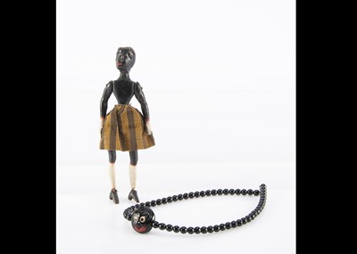 Lot 361 - A 19th century composition and carved wooden black jigger doll