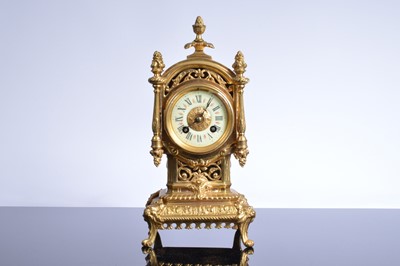 Lot 21 - A late 19th or early 20th century brass mantle clock garniture