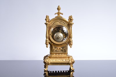 Lot 21 - A late 19th or early 20th century brass mantle clock garniture