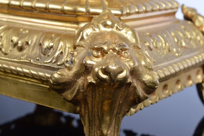 Lot 21 - A late 19th or early 20th century brass mantle clock garniture