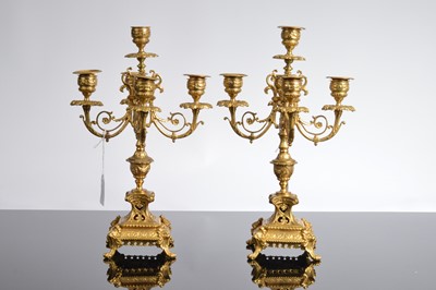 Lot 21 - A late 19th or early 20th century brass mantle clock garniture