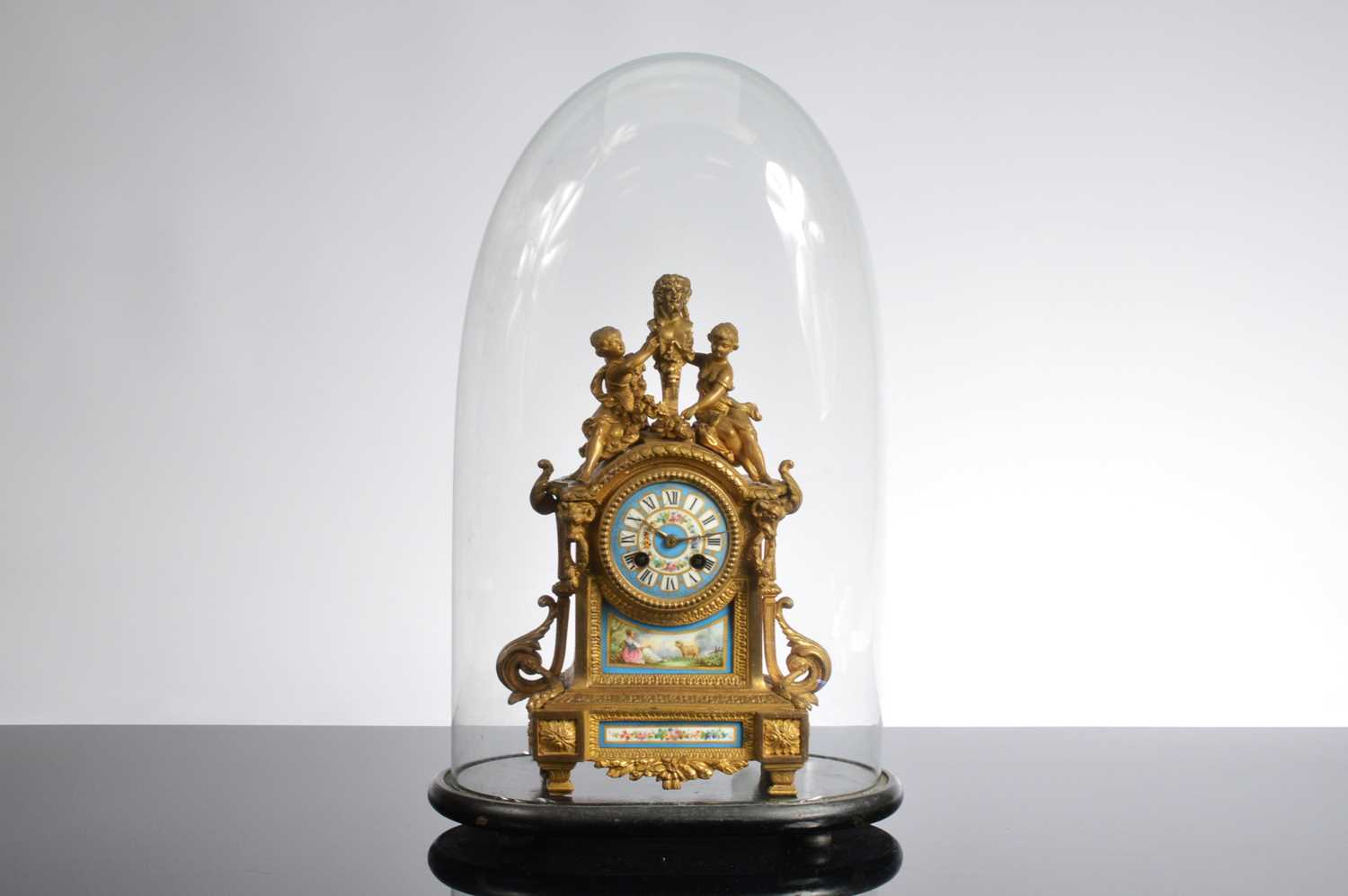 Lot 24 - A 19th century French Louis XVI style brass and porcelain mounted mantle clock