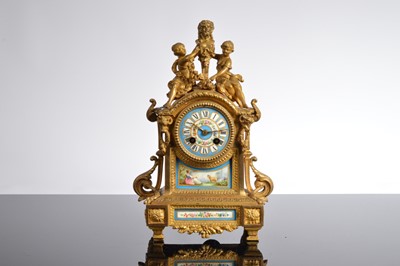 Lot 24 - A 19th century French Louis XVI style brass and porcelain mounted mantle clock