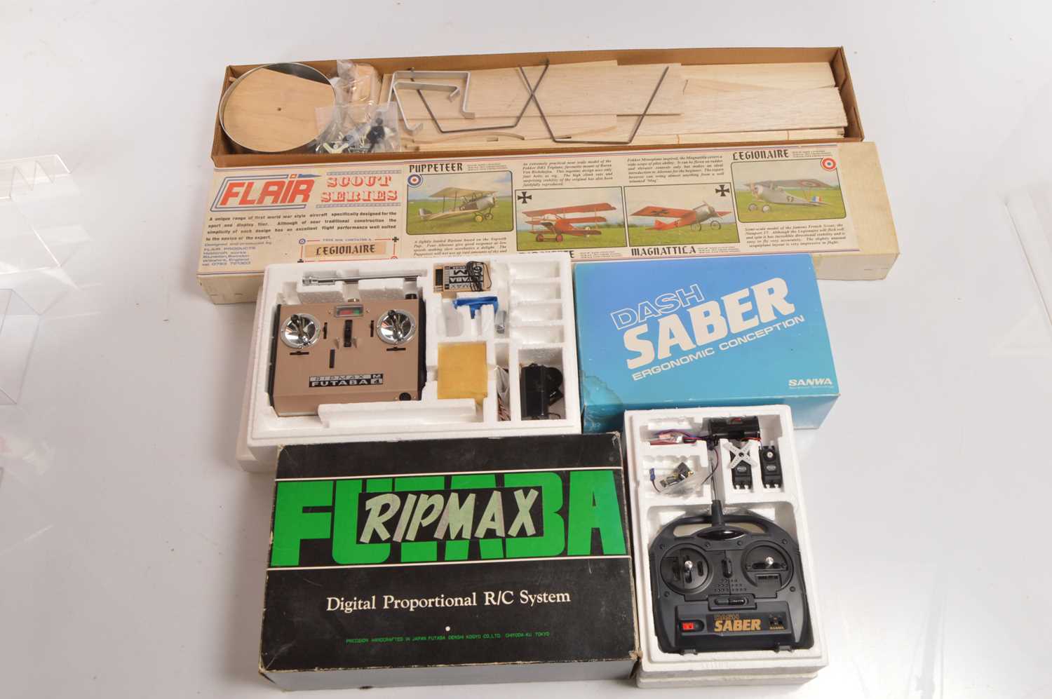 Lot 517 - Flair Scout Series Kit Model Bi-Plane and Two Boxed Radio Controls (3)