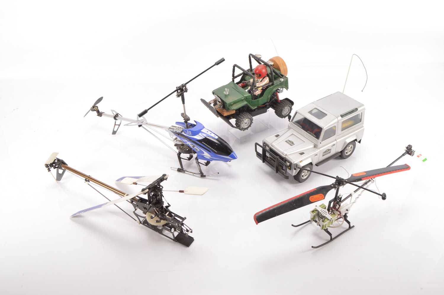 Lot 588 - Large collection of Radio Control Models and Spares including vehicles  Helicopters  RC Controls and spares including Petrol Engine Chargers Tyres Gyro Exhausts Propellers and other parts (qty in five