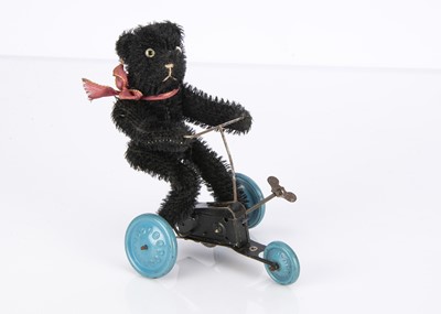 Lot 519 - An unusual German 1930s black mohair teddy bear on clockwork tricycle