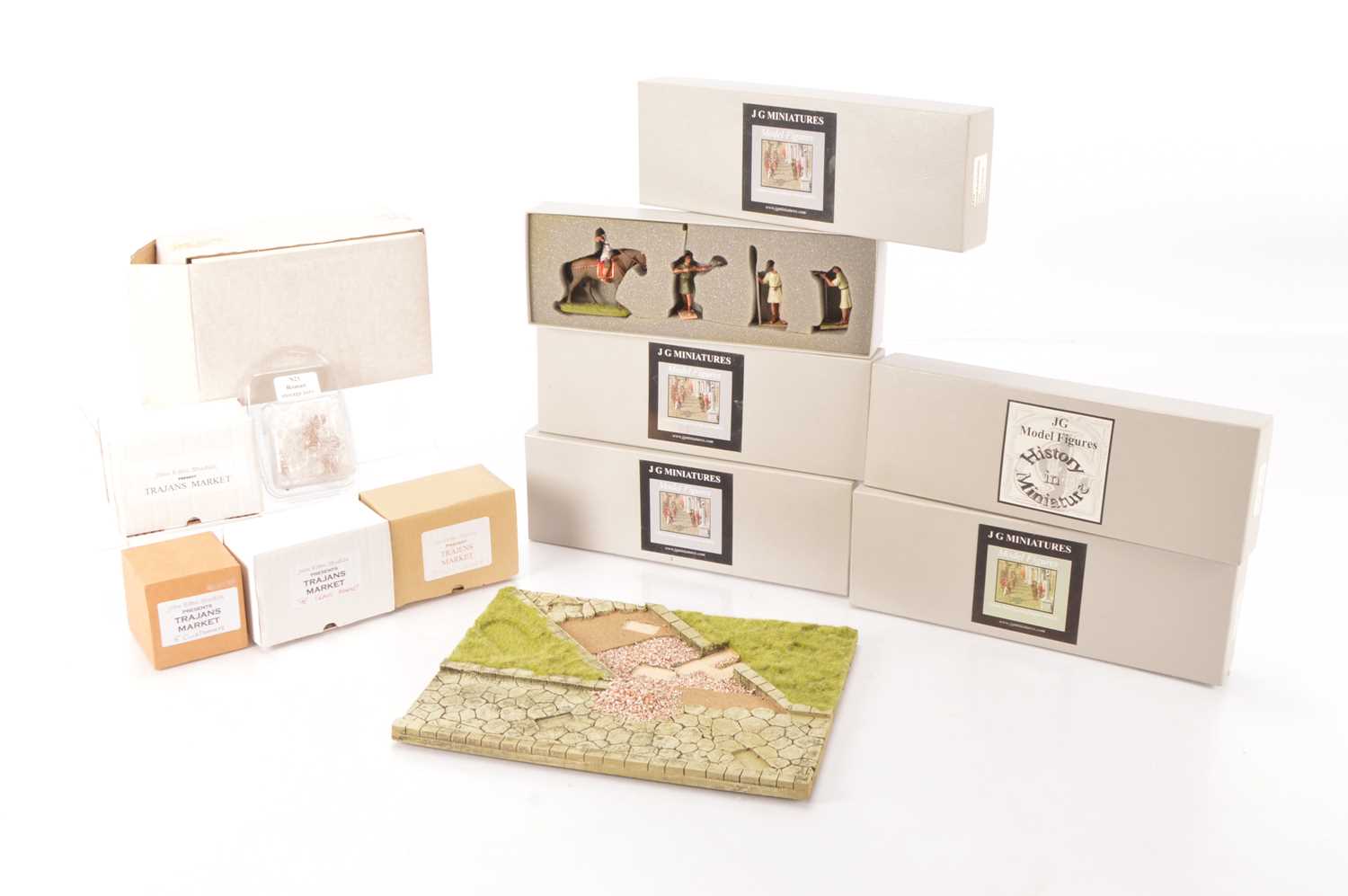 Lot 714 - J G Miniatures boxed Roman Figures including part of a Roman road and building crew and Stone masons house Stonemasons and Legionnaires and John Eden Studio Market stalls and Customers  (11 boxes and