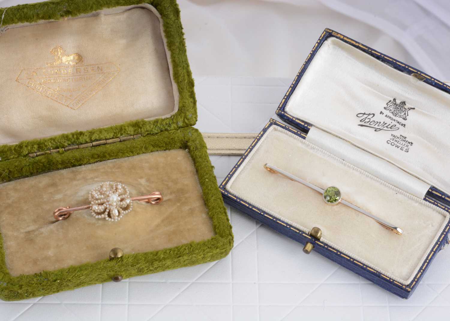 Lot 97 - A 15ct gold peridot and platinum set bar brooch