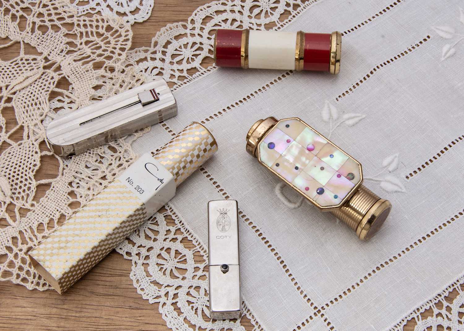 Lot 357 - Five Art Deco and later Coty lipsticks
