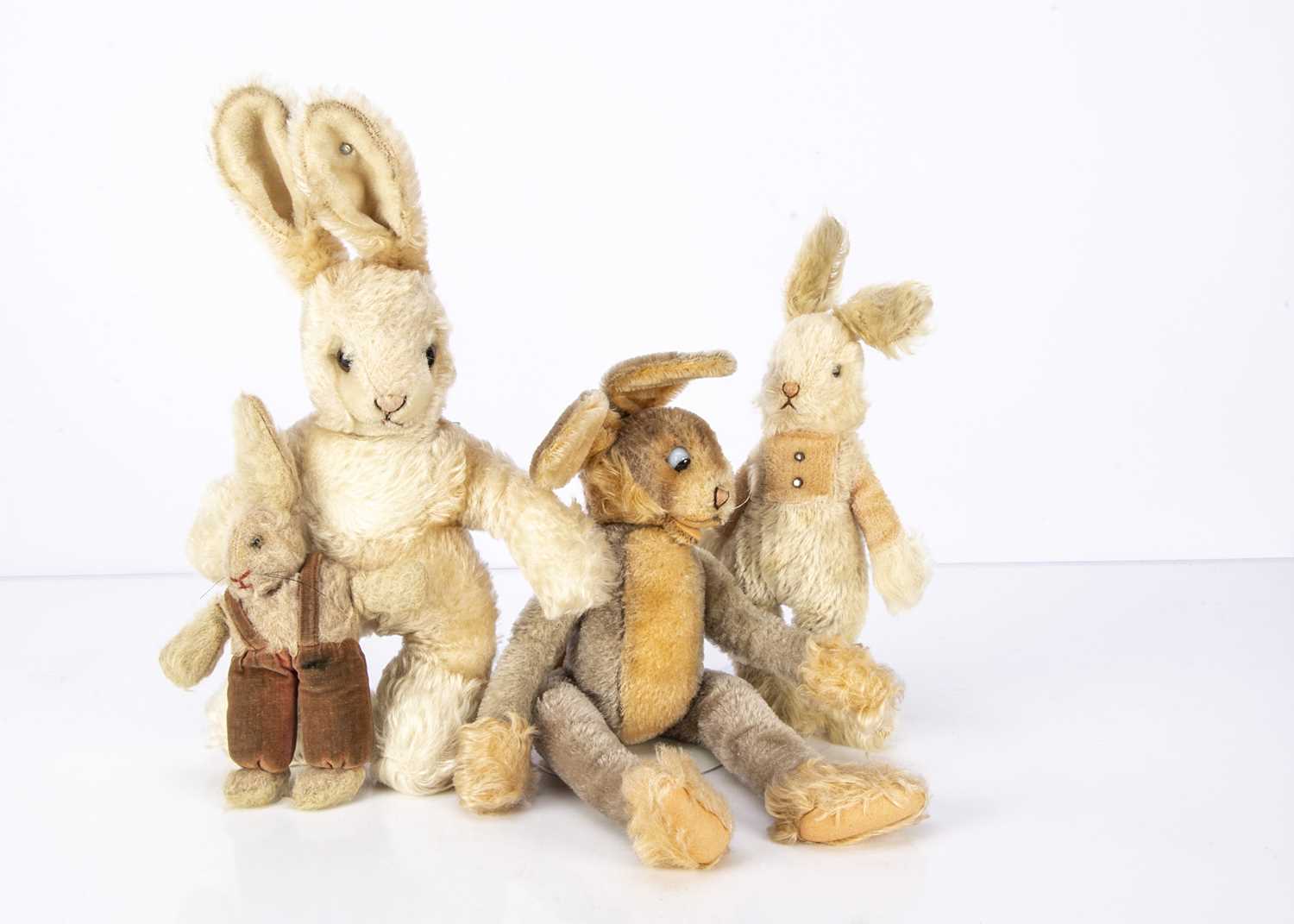 Lot 575 - Four soft toy rabbits,