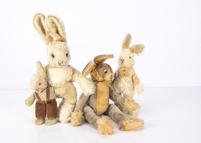 Lot 575 - Four soft toy rabbits
