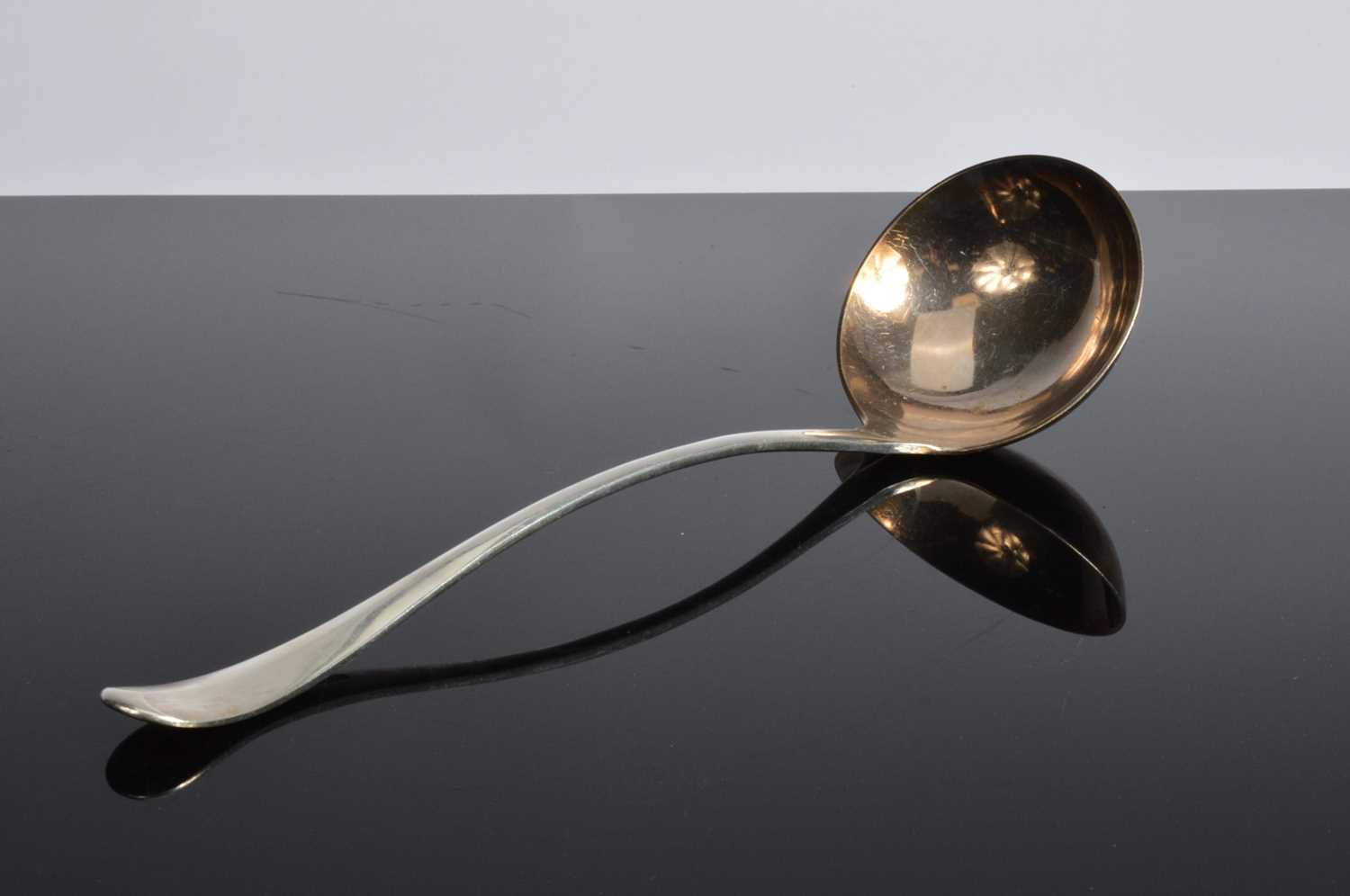 Lot 453 - An Edwardian silver soup ladle by JR