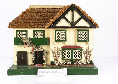 Lot 295 - A  Tudor Toys thatched cottage dolls' house
