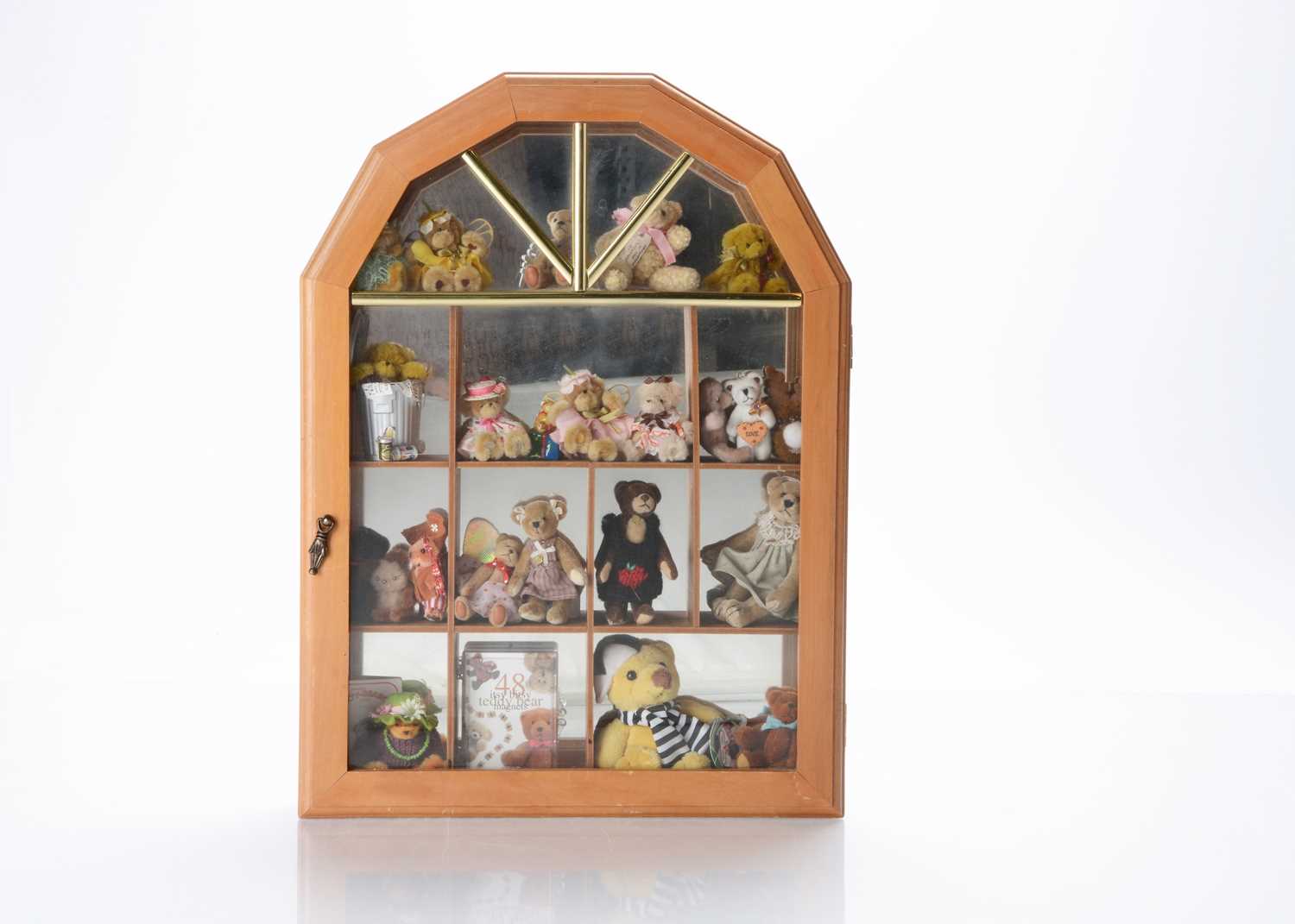 Lot 27 - A wooden glass fronted display cabinet, with collection of artist and manufactured small teddy bears