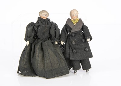 Lot 884 - Two bisque shoulder-head elderly couple dolls’ house dolls